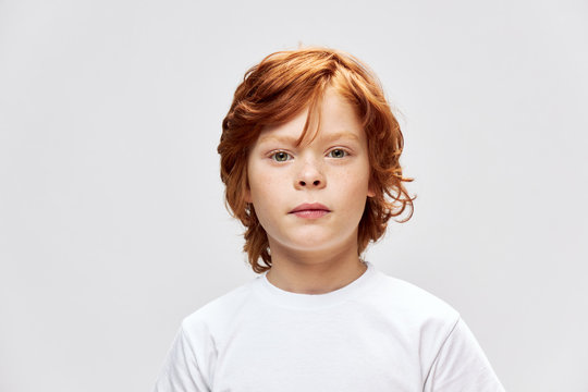 portrait of redhead boy cropped view white t-shirt studio close-up 
