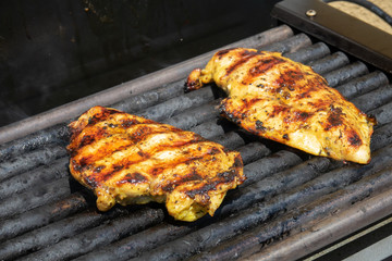 Chicken fillet on the grill. Grilled chicken breast