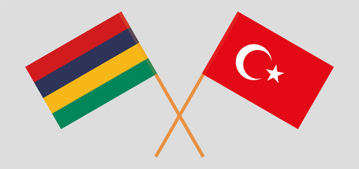Crossed and waving flags of Mauritius and Turkey