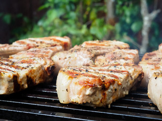 roasting steaks on the fire.flambé.flamber.meat on the bone on the grill.