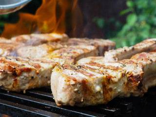 roasting steaks on the fire.flambé.flamber.meat on the bone on the grill.