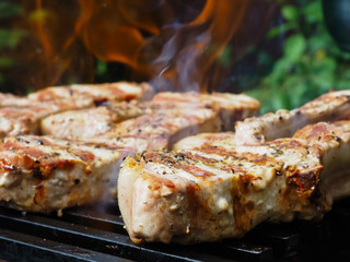 roasting steaks on the fire.flambé.flamber.meat on the bone on the grill.