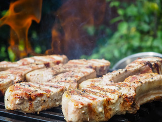 roasting steaks on the fire.flambé.flamber.meat on the bone on the grill.
