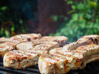 roasting steaks on the fire.flambé.flamber.meat on the bone on the grill.