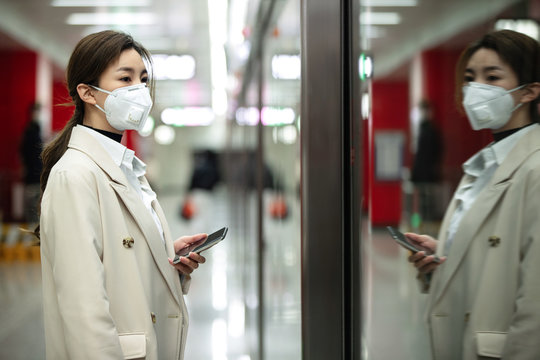 The young woman standing in the subway platform