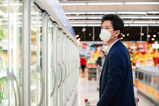 Wearing a mask of the young man shopping in the supermarket