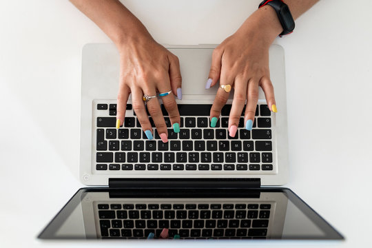 Close-up Of Woman Hands Using Laptop On Table At Home