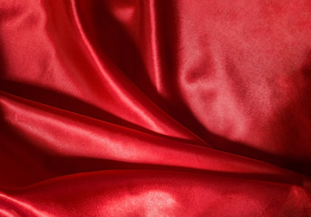Smooth, elegant red silky fabric. Selective focus.