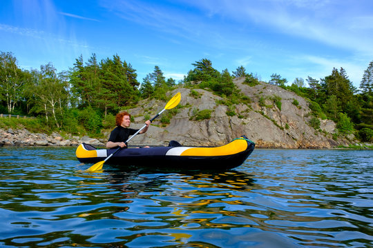 Sweden, Vastra Gotaland County, Kyrkesund, Teenage boy kayaking near coast of Lilla Askeron island