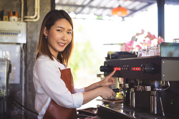 Fototapeta na wymiar Close up image of professional female barista preparing a fresh coffee at cafe.