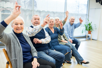 Senior citizens participating in group event in retirement home