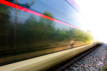 Naklejka premium Train in movement by rail with a blue sky