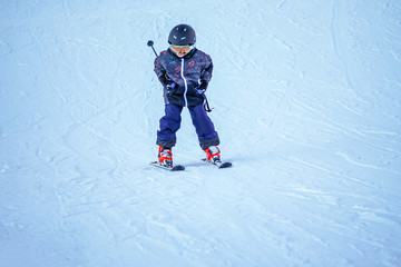 Fototapeta na wymiar Soft focus background. Young boy skiing downhill in ski resort. Winter season. 