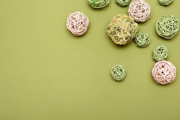 braided balls of pink and green color on a green background