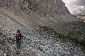 Fototapeta premium On trail from Coldai refuge via Coldai lake to Vazzoler refuge, along Civetta mountain range from north to south, stage 9 of Alta Via 1 classic long trek in the Dolomites, South Tirol, Italy.