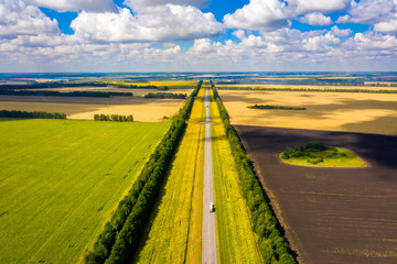 a straight road where cars are driving going over the horizon