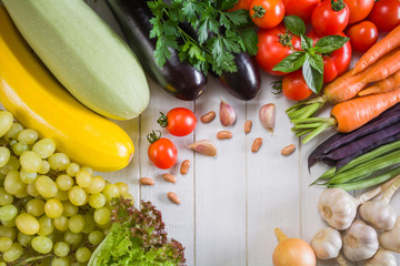 Fresh ripe vegetables and fruits on a white wooden table