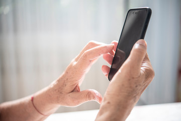 An elder lady using a smartphone