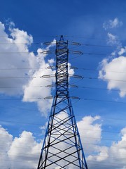 high-voltage pole with electric wires against the blue sky