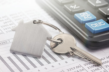 Real estate, keychain with house symbol. Calculator with finance blank.