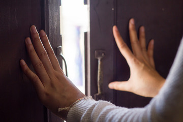 Women hand is opening the door or push the door into outside from the temple, Beautiful old wooden...