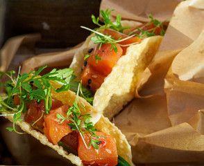 Salmon taco garnished with cilantro