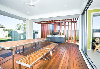 A modern backyard kitchen with outside grill