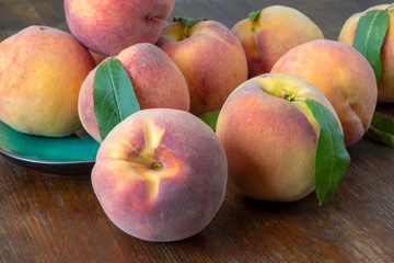 Fototapeta na wymiar Fresh peaches on a wooden table. Selective focus. 