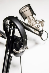 Headphones Rest on a Microphone Stand inside of a Podcast Studio