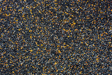 Background from small stone chips of black and orange colors. Ground coverage. Copy space. Texture