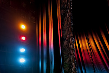 Austrian pleated main front stage curtain under the light of colorful stage floodlights