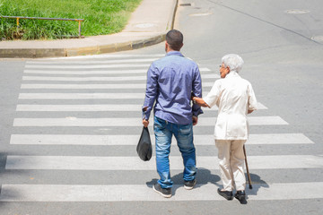 Son who helps his mother crosses the street 
