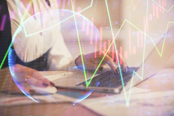 Double exposure of businesswoman hands typing on computer and forex graph hologram drawing. Financial analysis concept.