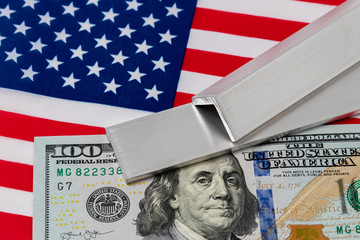 Aluminum metal stock and 100 dollar bill flag of United States of America. Concept of trade war, tariffs, fair trade and steel industry