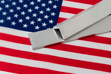 Aluminum metal stock on flag of United States of America. Concept of trade war, tariffs, fair trade...
