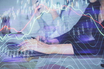 Multi exposure of woman hands typing on computer and financial graph hologram drawing. Stock market analysis concept.