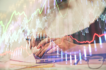 Multi exposure of woman hands typing on computer and financial graph hologram drawing. Stock market analysis concept.