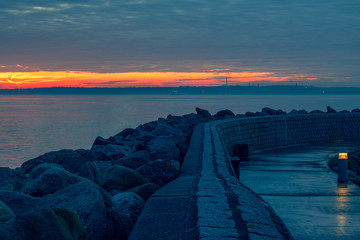 Sunset over the sea between the rocks