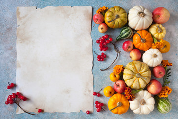 Background with paper for text, pumpkins, apples, viburnum, berries, marigolds, harvest and Thanksgiving.