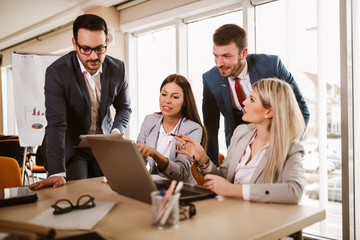 Business partners discussing documents and ideas at meeting