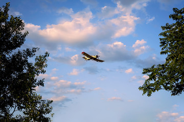 the airplane flying in the clouds in the beautiful sky