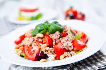 Salad with tuna, tomato, peanuts and fresh basil