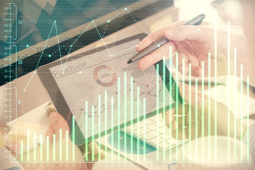 Double exposure of man's hands holding and using a phone and financial chart drawing. Market analysis concept.