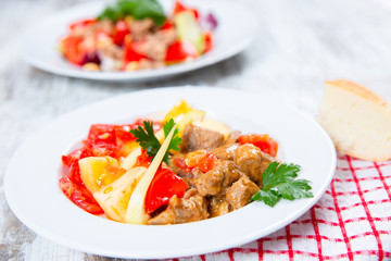 cooked meat with tomatoes and potatoes