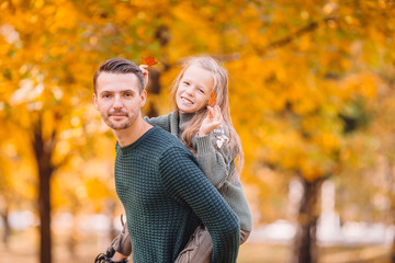 Fototapeta premium Family of dad and kid on beautiful autumn day in the park
