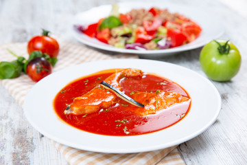 Fish soup in a white plate
