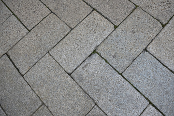 The texture of the paved tile on the bottom of the street. Cement brick squared stone floor background. Concrete paving slabs. Paving slabs
