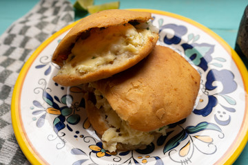 Mexican fried gorditas style michoacan with cheese on turquoise background