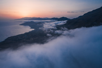 Sunset over the clouds and rugged south coast of Crete