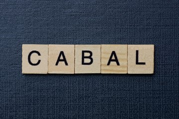gray word cabal from small wooden letters on a black table